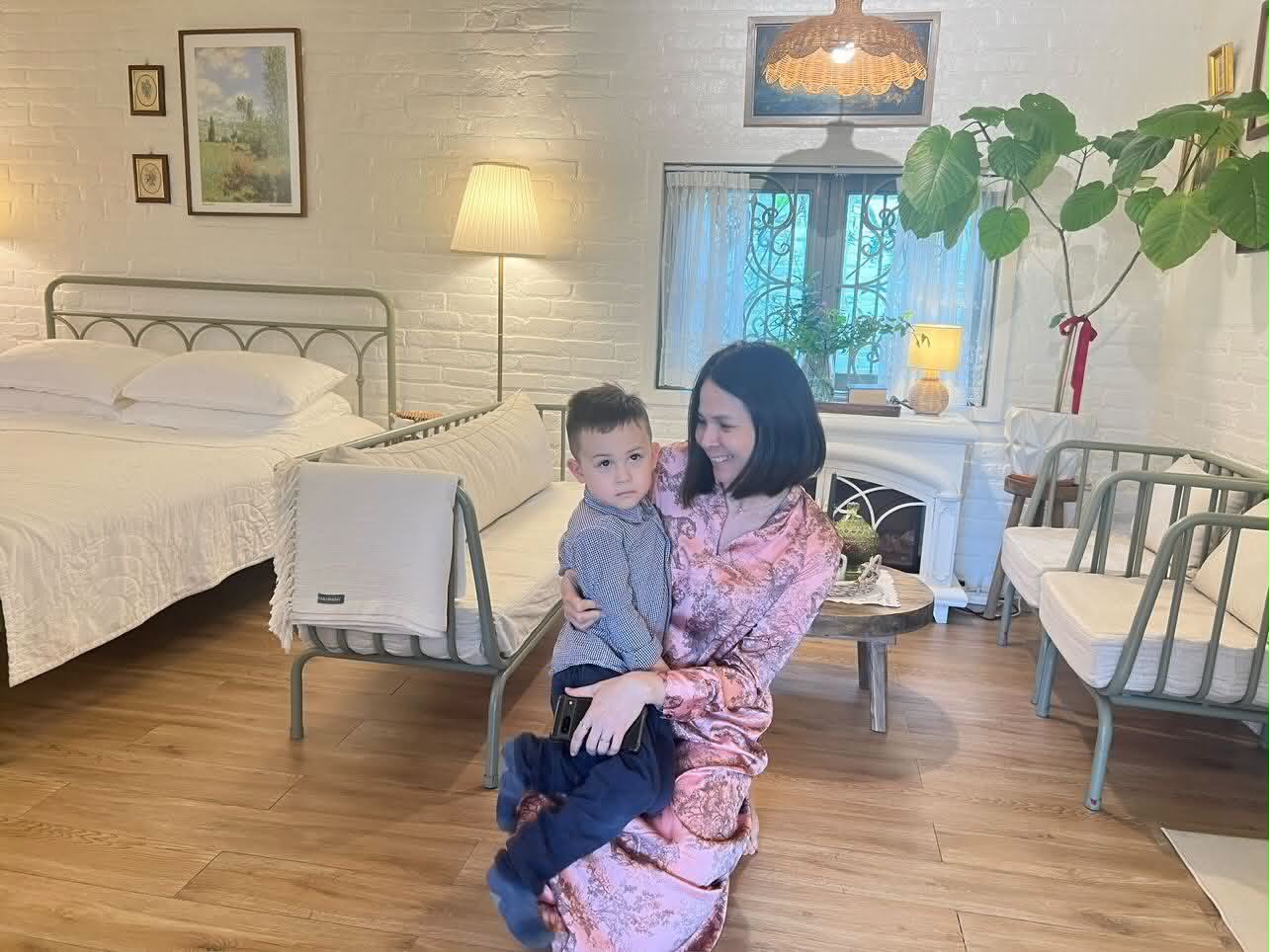 Lucie holding a child in a cozy room